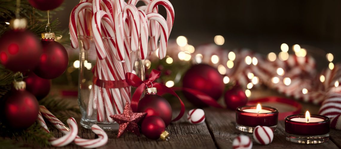 Candy Canes and Bright Christmas Lights on an Old Wood Background